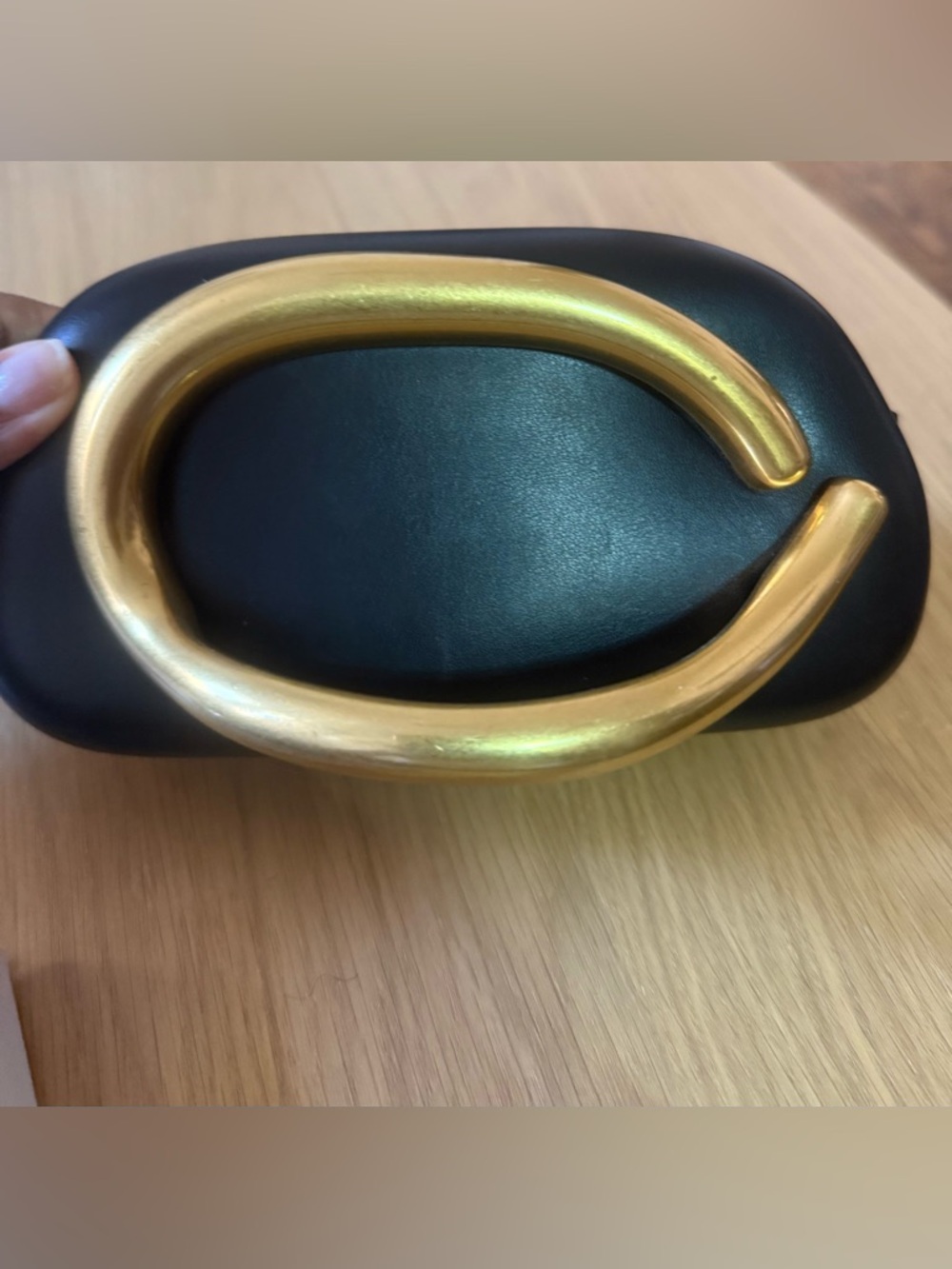 Black sleek bag with gold accent